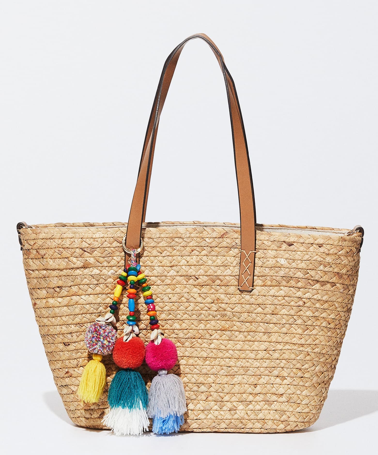 STRAW TOTE WITH LEATHER STRAP AND POM POM TASSEL