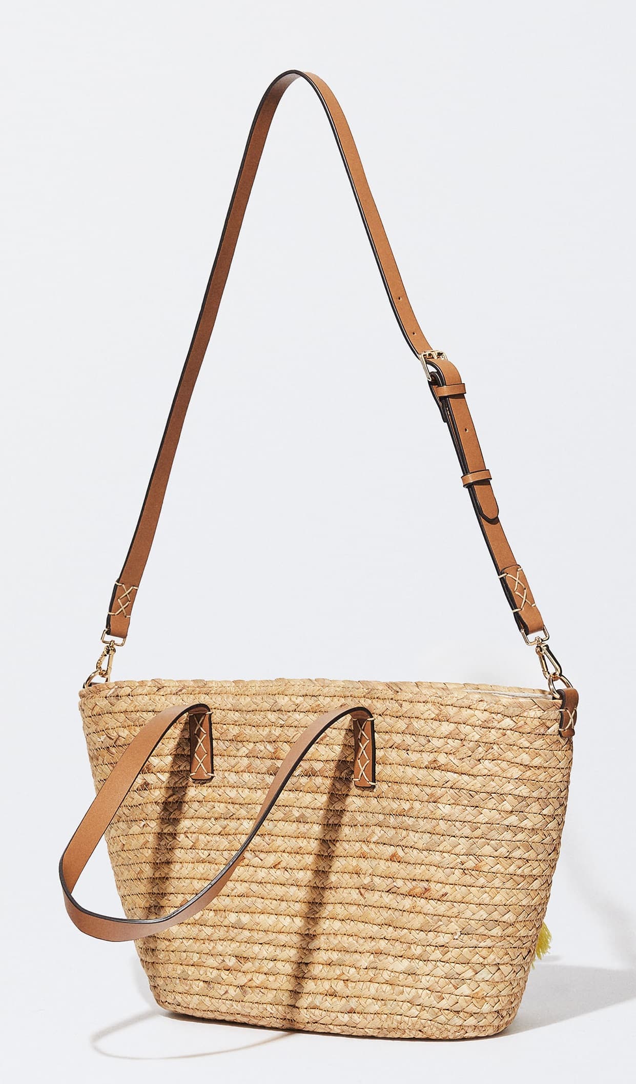 STRAW TOTE WITH LEATHER STRAP AND POM POM TASSEL