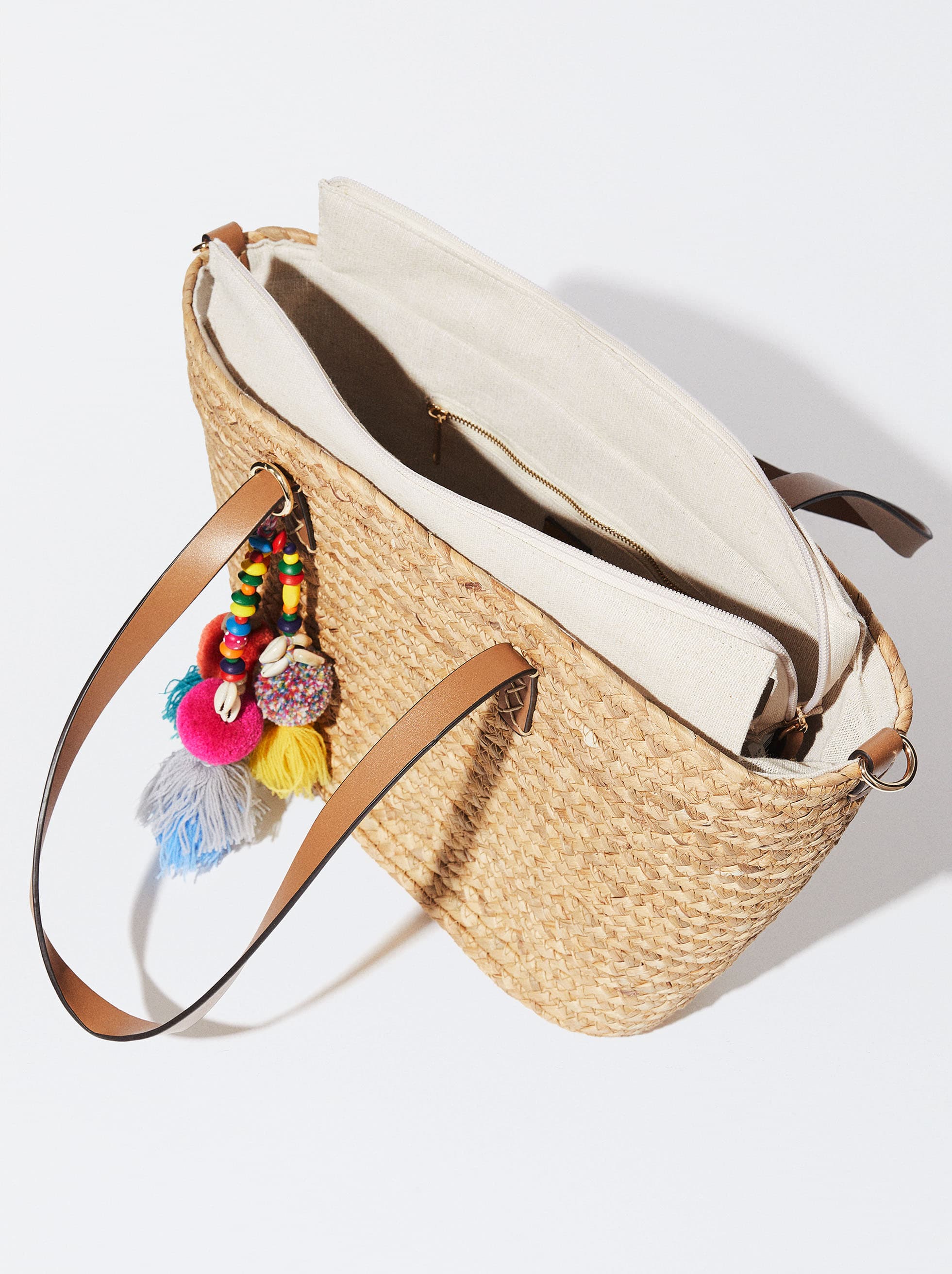 STRAW TOTE WITH LEATHER STRAP AND POM POM TASSEL