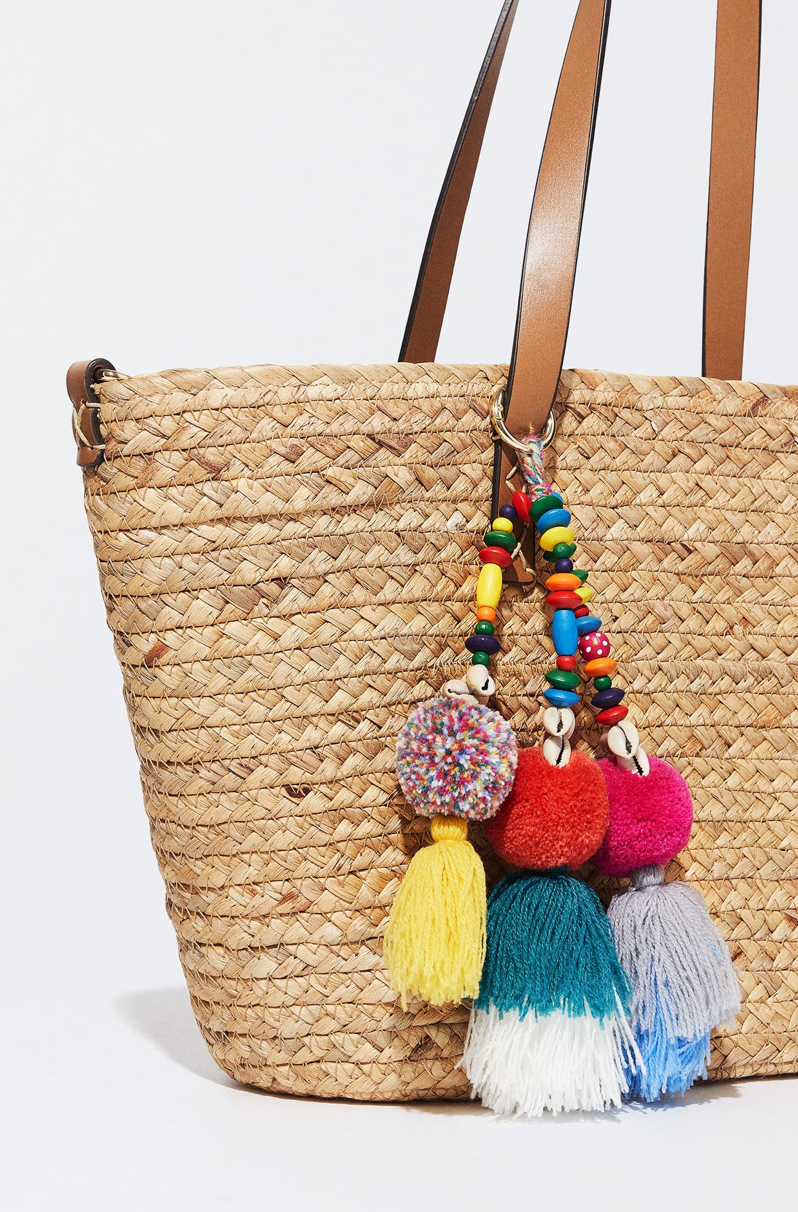 STRAW TOTE WITH LEATHER STRAP AND POM POM TASSEL