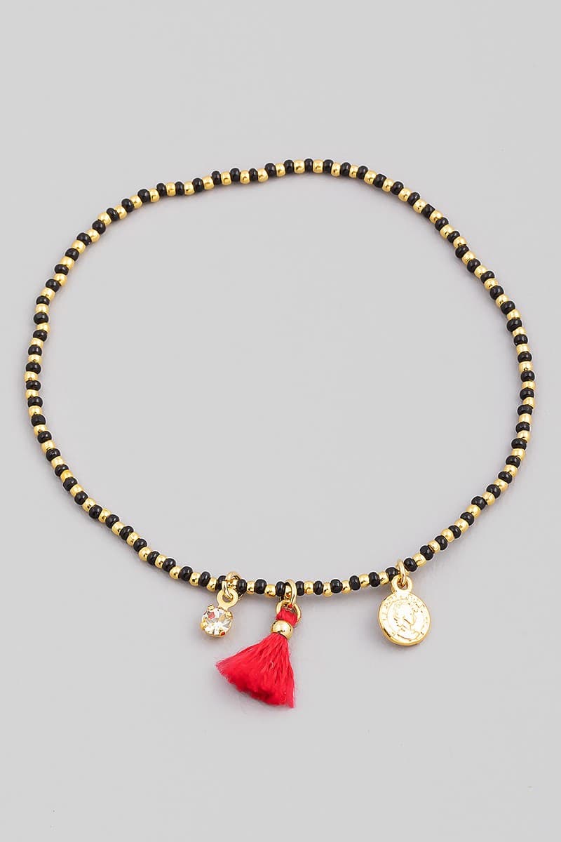 SEED BEAD STRETCH BRACELET WITH CHARM AND TASSEL