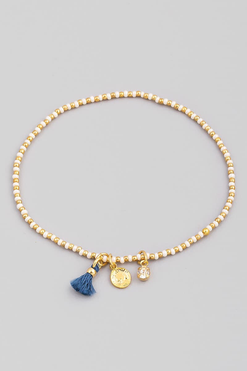 SEED BEAD STRETCH BRACELET WITH CHARM AND TASSEL