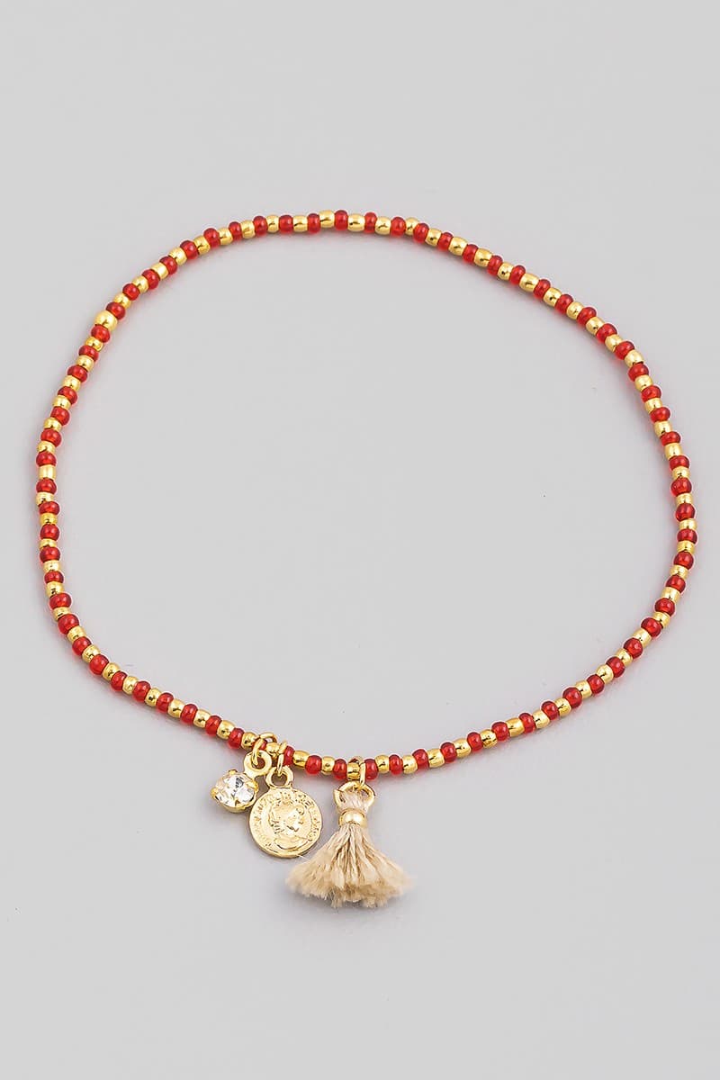 SEED BEAD STRETCH BRACELET WITH CHARM AND TASSEL