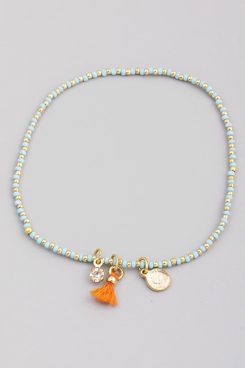 SEED BEAD STRETCH BRACELET WITH CHARM AND TASSEL