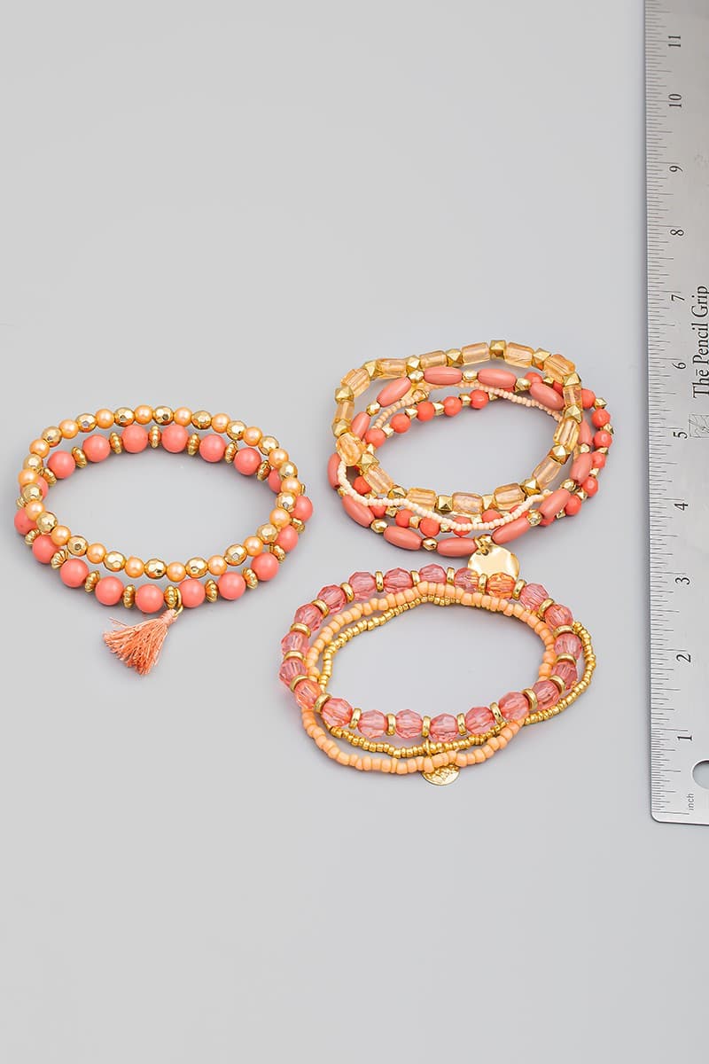 PINK MULTI ROW STRETCH BRACELET WITH TASSEL